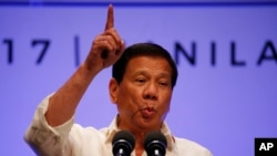 FILE - Philippines President Rodrigo Duterte gestures while addressing the media following the conclusion of the 30th ASEAN Leaders' Summit in Manila, Philippines.