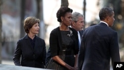 President Barack Obama, first lady Michelle Obama, former President George W. Bush and former first lady Laura Bush visit North Memorial Pond at the National 9/11 Memorial in New York City, Sunday, September, 11, 2011.