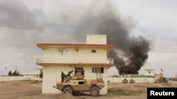 Smoke billows from a building after a Taliban attack in Gereshk district of Helmand province, Afghanistan on March 9, 2016. 