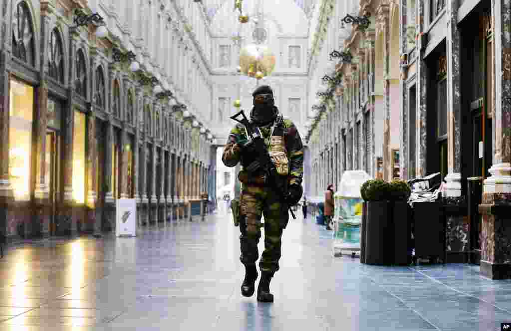 A Belgian Army soldier walks through the Galleries Royal Saint-Hubert in the center of Brussels.&nbsp;