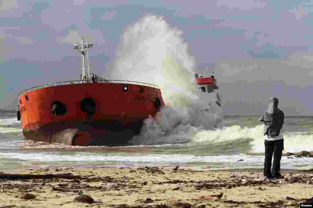 Waves hit an Indonesian tanker that ran aground near Narathiwat in southern Thailand. The tanker, loaded with palm oil and previously hijacked by its crew members and then seized by Thai authorities, was anchored some 400 meters from the beach but strong wind and waves broke it free.