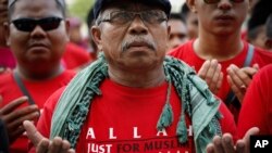 Muslim demonstrators pray outside the Court of Appeal in Putrajaya, outside Kuala Lumpur, Malaysia, Oct. 14, 2013.