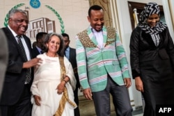 Sahle-Work Zewde (2-L) walks with Prime Minister Abiy Ahmed (2-R) after being elected Ethiopia’s first female president, at the Parliament in Addis Ababa, Oct. 25, 2018.