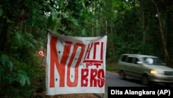 A roadside sign that reads "no to industrial forestry plantations and BRS," or Bangun Rimba Sejahtera, the company that is being used to push Asia Pulp & Paper's expansion in the area.