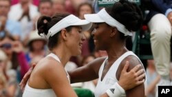 Spain's Garbine Muguruza greets Venus Williams of the United States at the net after winning the Women's Singles final match on day twelve at the Wimbledon Tennis Championships in London, July 15, 2017. 