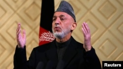 Afghan President Hamid Karzai speaks during a ceremony to mark the 80th anniversary of Kabul University in Kabul, May 9, 201