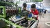 Palestinians work at a textile factory in the Industrial Park of the West Bank Jewish settlement of Barkan, Nov. 8, 2015. 