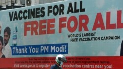 A motorist drives past a billboard advertising free COVID-19 vaccines for all citizens near a vaccination center in Mumbai, September 14, 2021.