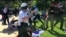 FILE - Police in Washington try to break up a clash between protesters and supporters of Turkish President Recep Tayyip Erdogan near the Turkish ambassador's residence, May 16, 2017, in this still image from video.