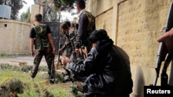 Free Syrian Army fighters carrying weapons, take up position during clashes with forces loyal to Syria's President Bashar al-Assad in the Khan al-Assal area, near Aleppo Apr. 20, 2013.