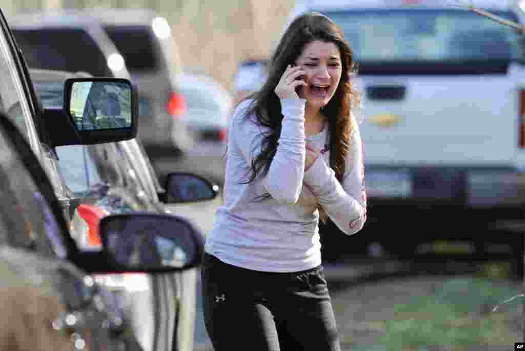 A woman waits to hear about her sister, a teacher, following a shooting at the Sandy Hook Elementary School in Newtown, Connecticut.