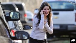 A woman waits to hear about her sister, a teacher, following a shooting at the Sandy Hook Elementary School in Newtown, Connecticut.