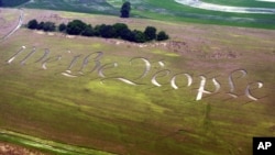 "We the People," the beginning of the preamble of the U.S. Constitution, is seen cut into a wheat field on the farm of Jack Coleman in Ronks, Pa., June 26, 2003. (AP Photo/Chris Gardner)