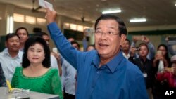 FILE - Prime Minister Hun Sen of the Cambodian People's Party shows off his ballot paper at Takhmau polling station in Kandal province, southeast of Phnom Penh, June 4, 2017.