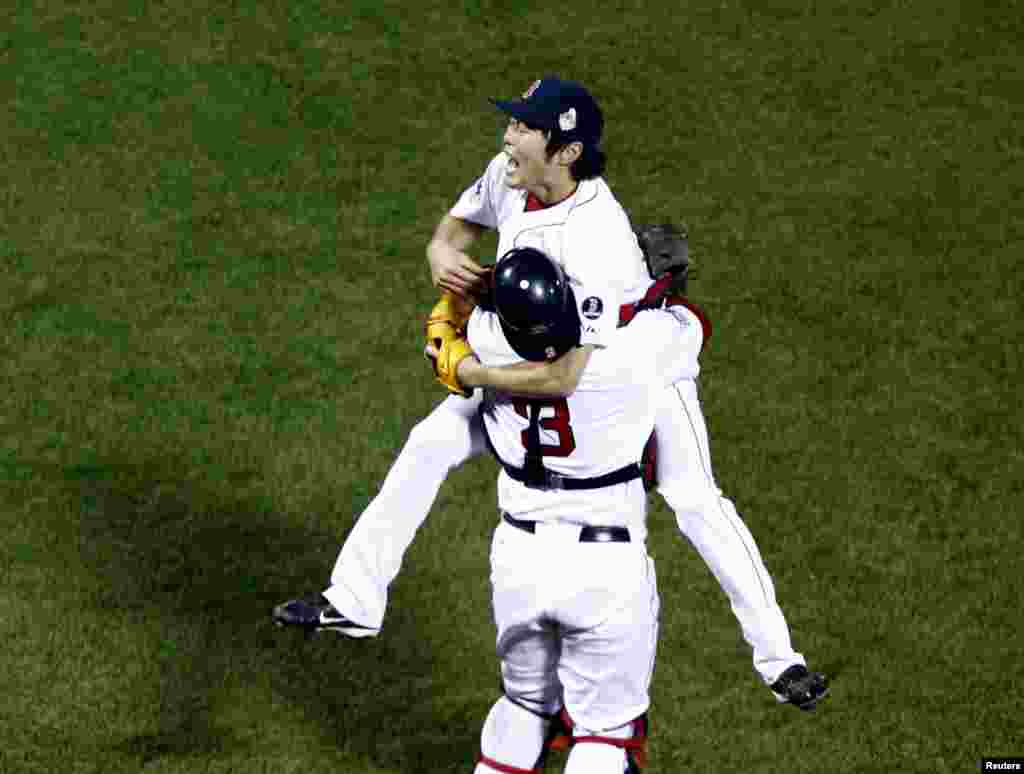 Oct 30, 2013; Boston, MA, USA; Boston Red Sox relief pitcher Koji Uehara (19) reacts with catcher David Ross (3) after defeating the St. Louis Cardinals in game six of the MLB baseball World Series at Fenway Park. Red Sox won 6-1. Mandatory Credit: Mark L