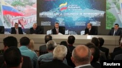 FILE - Venezuela's Vice President Tareck El Aissami (C) speaks during a meeting with bondholders and their representatives, and government officials, in Caracas, Venezuela, Nov. 13, 2017.