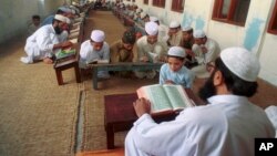 An undated photo of Pakistani children studying the Quran at a religious school in Lahore, Pakistan. Pakistan's religious schools, or madrassas, face renewed scrutiny with many alleging that the schools serve as breeding grounds for violent extremists.