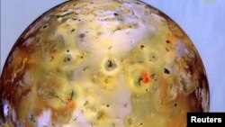Jupiter's moon Io, the most volcanic body in the solar system, is seen in front of Jupiter's cloudy atmosphere in this image made from NASA's Galileo spacecraft and released Oct. 24. NASA's Bradford Smith, who acted as the "nation's tour guide" to photos from the Voyager probes, famously said of Io: “I’ve seen better looking pizzas than this.” 