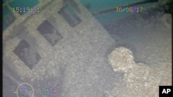 This 2017 image from video provided by the National Oceanic and Atmospheric Administration Thunder Bay National Marine Sanctuary shows the capstan and pilot house of the 202-foot-long wooden bulk carrier Ohio. The ship went down in Lake Huron in 1894, in more than 200 feet of water. The shipwreck has been discovered more than a century later.