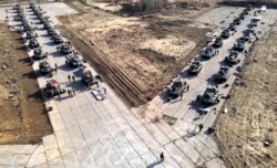 FILE - This image released by the Russian Defense Ministry Press Service shows Russian military vehicles during drills in Crimea, Apr. 22, 2021.