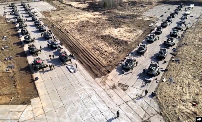 FILE - This image released by the Russian Defense Ministry Press Service shows Russian military vehicles during drills in Crimea, Apr. 22, 2021.