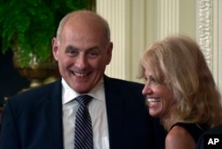 FILE - White House chief of staff John Kelly, left, and White House counselor Kellyanne Conway laugh before the start of a news conference.