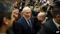 FILE - Mikhail Khodorkovsky (C) arrives at his first news conference after his release in Berlin, Germany, Dec. 22, 2013.