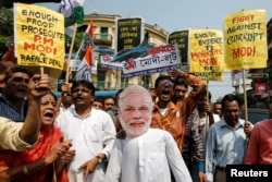 Supporters of India's main opposition Congress shout slogans against Prime Minister Narendra Modi during a protest over allegations of corruption in a Rafale fighter planes deal with France, in Kolkata, India, March 7, 2019.