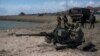 Ukrainian servicemen deploy a weapon at the beach of the Azov Sea in Shyrokyne, eastern Ukraine, April 15, 2015. 