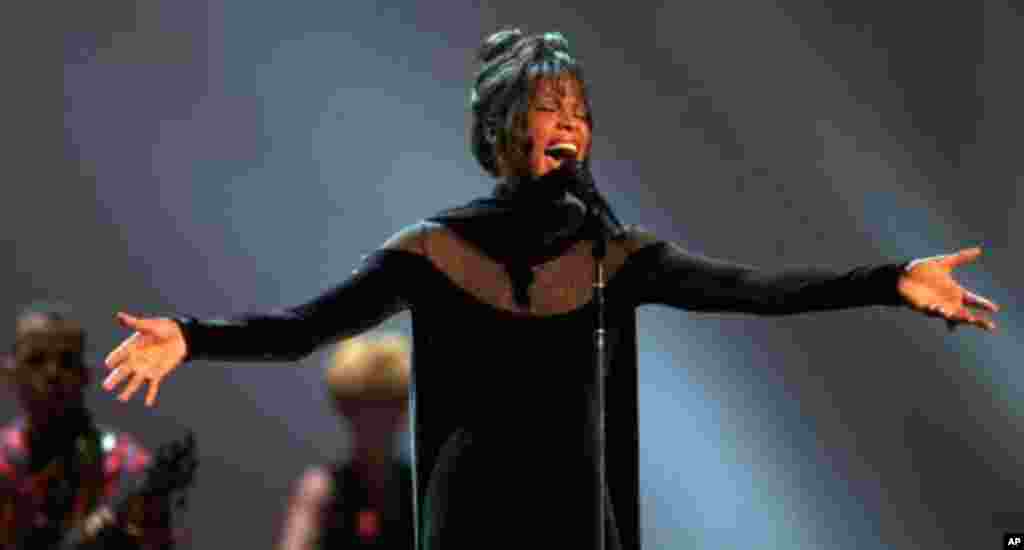 Whitney Houston performs during the 21st annual American Music Awards at the Shrine Auditorium Feb. 7, 1994 in Los Angeles. On the strength of "The Bodyguard" soundtrack, the vocalist swept the awards with seven honors and also was named recipient of the