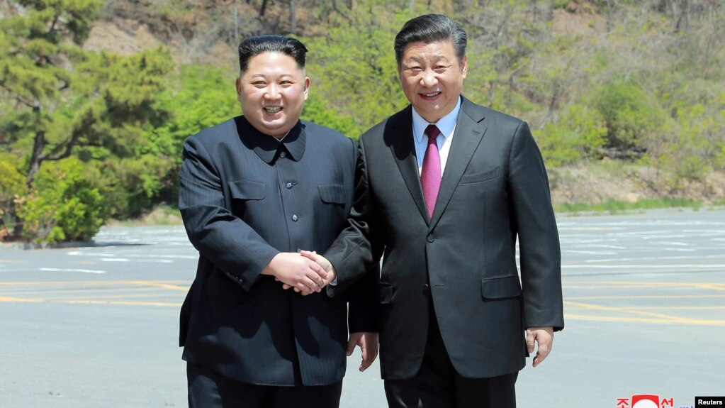 North Korean leader Kim Jong Un shakes hands with China's President Xi Jinping, in Dalian, China in this undated photo released on May 9, 2018 by North Korea's Korean Central News Agency (KCNA).