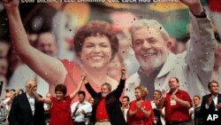 FILE - Brazil's President Luiz Inacio Lula da Silva, center, raises arms with his Chief of Staff Dilma Rousseff at an annual Workers Party Congress in Brasilia, Brazil, Feb. 20, 2010. 