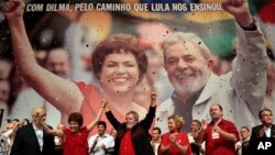 FILE - Brazil's President Luiz Inacio Lula da Silva, center, raises arms with his Chief of Staff Dilma Rousseff at an annual Workers Party Congress in Brasilia, Brazil, where the party announced Rousseff as the party's 2010 presidential candidate, Feb. 20