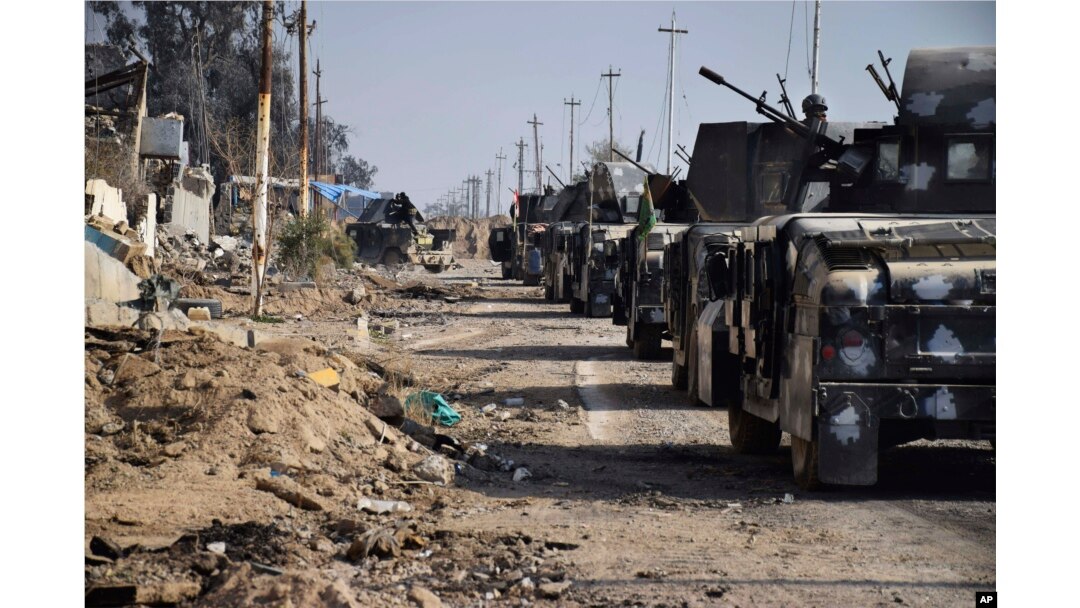 Iraqi security forces surround the government complex in central Ramadi, 70 miles (115 kilometers) west of Baghdad, Iraq, Monday, Dec. 28, 2015.