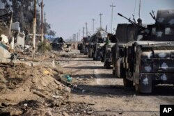Iraqi security forces surround the government complex in central Ramadi, 70 miles (115 kilometers) west of Baghdad, Iraq, Monday, Dec. 28, 2015.