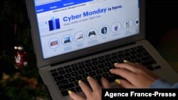 FILE - In this photo illustration, an ad for a Cyber Monday sale is displayed on a laptop on Nov. 30, 2020 in Arlington, Va.