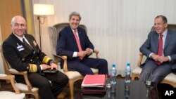 FILE - From left, Vice Admiral Kurt Tidd, U.S. Secretary of State John Kerry and Russia's Foreign Minister Sergei Lavrov sit for a photo opportunity, Nov. 23, 2013, in Geneva, Switzerland, during the Iran nuclear talks. Tidd said Tuesday that the flow of foreign fighters from Latin America to the Middle East has been "significantly curtailed."