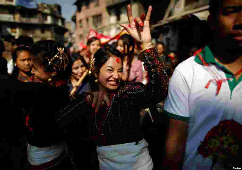 Participants from Newar community in traditional attire, dance during the Newari New Year parade, also called Diwali, in Kathmandu, Nepal.