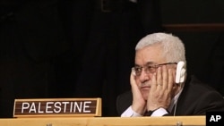 Palestinian President Mahmoud Abbas listens to US President Barack Obama's remarks during the 66th session of the General Assembly at United Nations headquarters, New York, September 21, 2011.