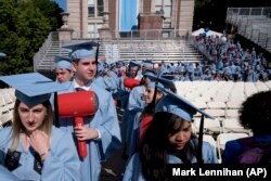 Students in the engineering department carry toy hammers as they arrive to receive their degrees at Columbia University's commencement, Wednesday, May 22, 2019 in New York.