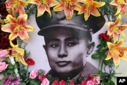 A portrait of Gen. Aung San is decorated with flowers during a ceremony marking the 70th anniversary of his 1947 assassination in Naypyitaw, Myanmar, July 19, 2017.