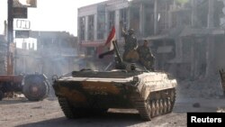 Syrian troops roll into the center of Qusair June 5, 2013, after capturing the stragegic town with key help from Lebanese Hezbollah fighters.