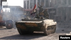 Syrian troops roll into the center of Qusair June 5, 2013, after capturing the stragegic town with key help from Lebanese Hezbollah fighters.