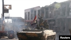 Syrian troops roll into the center of Qusair June 5, 2013, after capturing the stragegic town with key help from Lebanese Hezbollah fighters.