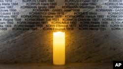 FILE -A light illuminates names at the Shoah Wall of Names Memorial during the inauguration ceremony in Vienna, Austria, Nov. 9, 2021. Vienna born Holocaust survivor Gertrude Pressburger has died at age 94, Jan. 1, 2022.