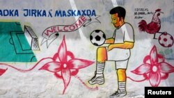 FILE - A mural depicting a soccer player is seen on a wall of a stadium in the Hodan district of Mogadishu, Somalia, June 13, 2017. 