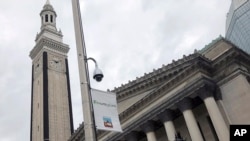 In this Thursday, Oct. 17, 2019 photo, a video surveillance camera hangs on a pole outside City Hall in Springfield, Mass. (AP Photo/Matt O'Brien)