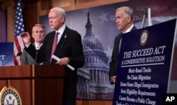 Sen. Orrin Hatch, R-Utah, center, flanked by Sen. James Lankford, R-Okla., left, and Sen. Thom Tillis, R-N.C., talk about the legislation they are introducing regarding the legal status of undocumented children during a news conference on Capitol Hill.