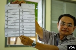 An election officer displays a ballot that was invalidated with cross-outs at the Boeng Keng Kong 2 commune, Chamkamon district, in Phnom Penh on election day. (Khan Sokummono/VOA Khmer)