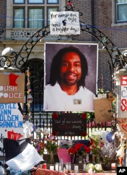 FILE - A memorial including a photo of Philando Castile adorns the gate to the governor's residence, July 25, 2016, where protesters demonstrated in St. Paul, Minn., against the July 6 shooting death of Castile by Police Officer Jeronimo Yanez.